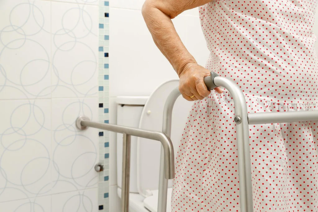 elderly-woman-holding-on-walker-in-toilet
