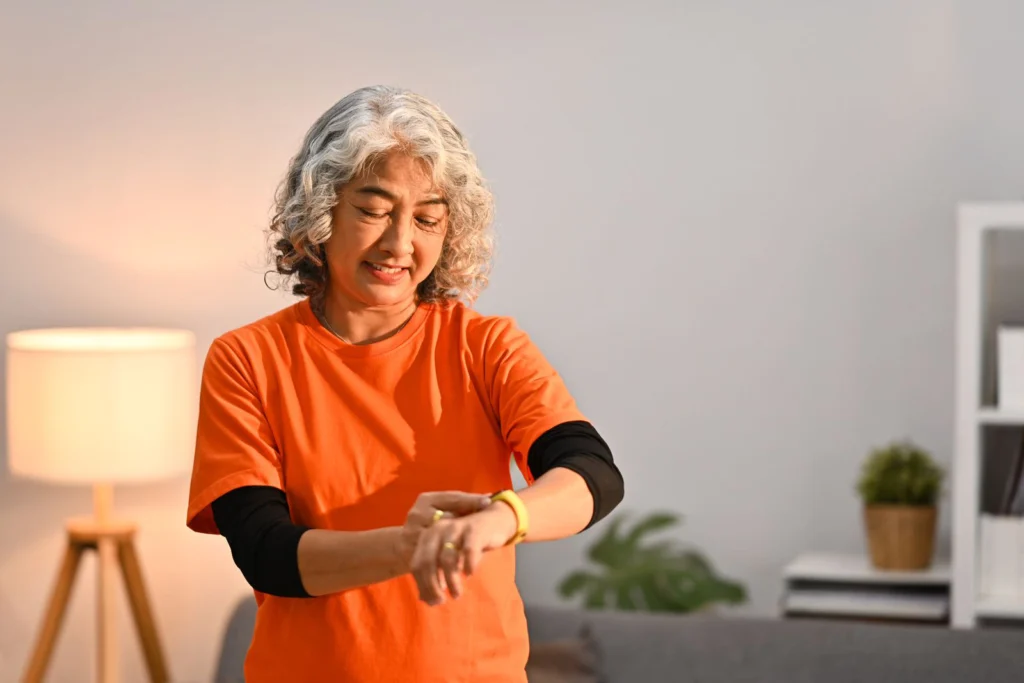 pleasant-middle-aged-woman-checking-her-heart-rate-data-on-smartwatch-after-workout-at-home-healthy-lifestyle-concept